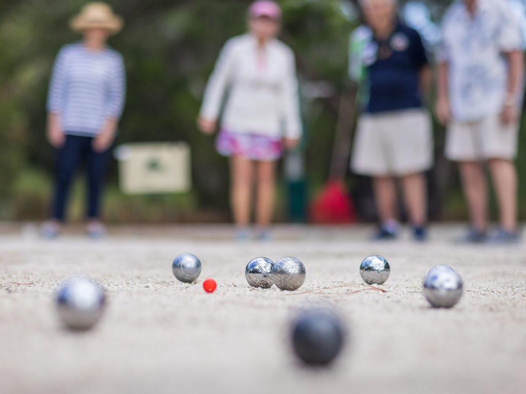 A group of people playing petanque